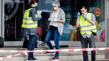 Police officers secure evidence at a supermarket Friday in Hamburg, Germany, after a knifing attack.