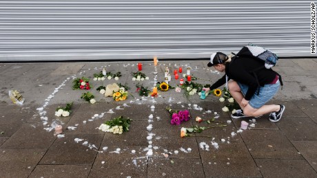 A woman places flowers  near the scene of the attack Saturday in Hamburg. 