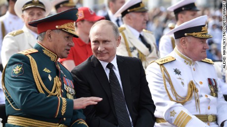 Russian Defense Minister Sergei Shoigu, President Vladimir Putin, and the commander-in-chief of the Russian Navy Adm. Vladimir Korolev review a naval parade in St. Petersburg.
