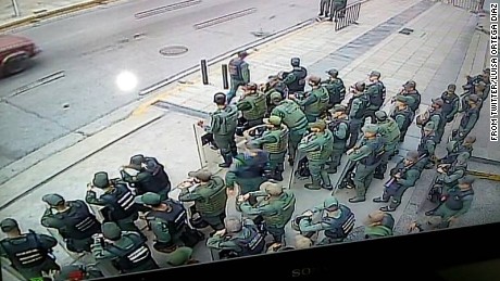 An image distributed by Ortega&#39;s press office shows troops outside her office in the capital, Caracas.