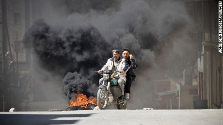 A photo taken by John Cantlie of citizens fleeing clashes in Saraqib, Syria, in 2012.