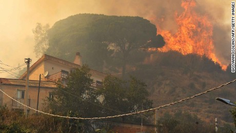 A blaze rises above a community in Sicily.