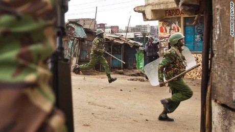 Kenyan security forces chase demonstrators in the Mathare area of Nairobi on Wednesday. 