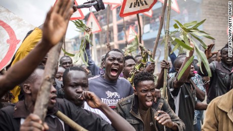 Supporters of opposition presidential candidate Raila Odinga shout and brandish sticks during a protest in the Mathare slums of Nairobi on Wednesday. 