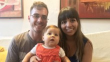  Carolina Wong and Jorge Salas sit with their daughter, Akira, before they leave Venezuela for Peru. 