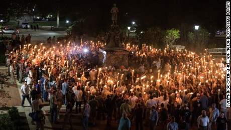 White nationalists carrying torches surround protesters Friday night at the foot of a statue of Thomas Jefferson on the University of Virginia&#39;s campus.
