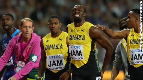 The agony is clear for all to see as Bolt is comforted by Jamaican teammates. 