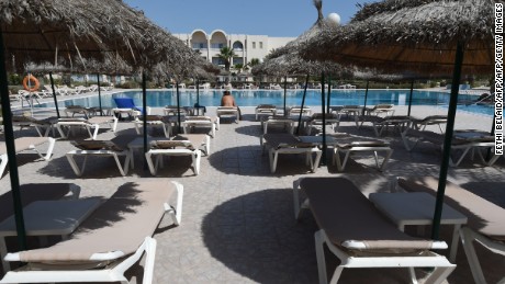 A tourist on a sunbed on the Tunisian resort island of Djerba. Visitor numbers fell by 25% in 2015 after ISIS attacks on tourist sites. 