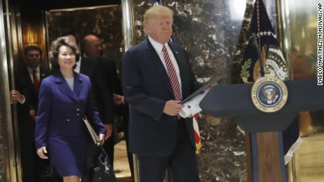 President Donald Trump, followed by Transportation Secretary Elaine Chao, arrives to speaks to the media in the lobby of Trump Tower in New York, Tuesday, Aug. 15, 2017. (AP Photo/Pablo Martinez Monsivais)