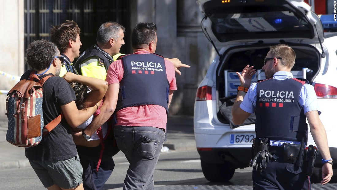 An injured person is carried by police in Barcelona.