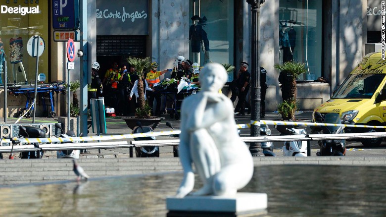 A person is stretched out of a mall by medical staff members in a cordoned off area after a van ploughed into the crowd, injuring several persons on the Rambla in Barcelona on August 17, 2017.
Police in Barcelona said they were dealing with a "terrorist attack" after a vehicle ploughed into a crowd of pedestrians on the city's famous Las Ramblas boulevard on August 17, 2017. Police were clearing the area after the incident, which has left a number of people injured. / AFP PHOTO / Josep LAGO        (Photo credit should read JOSEP LAGO/AFP/Getty Images)