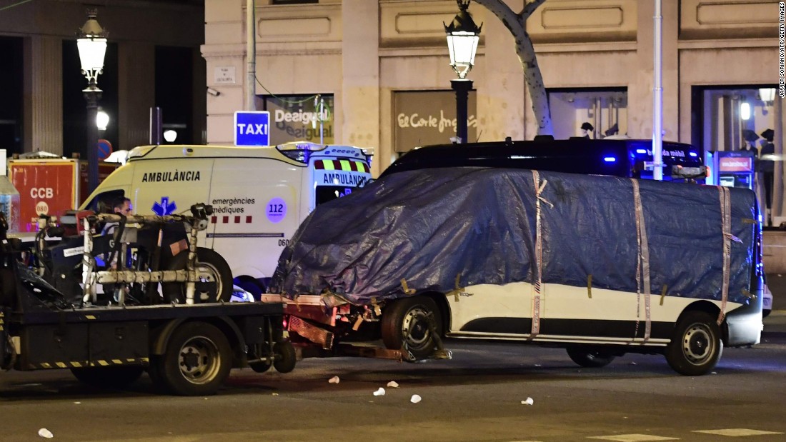 The van that plowed into the crowd in Barcelona is towed away from Las Ramblas on August 18.