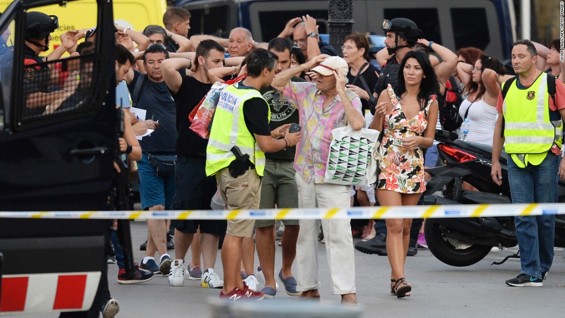 Police check people&#39;s identities as they clear Las Ramblas on August 17.