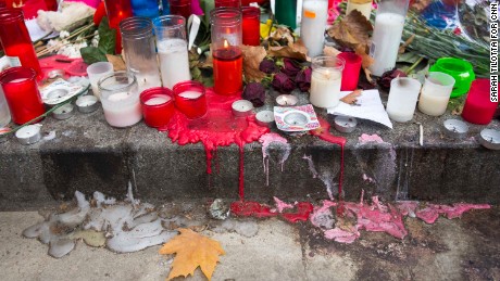 Candle wax melts down the curb at a makeshift memorial on Las Ramblas in Barcelona, where the van attack killed 13 people on Thursday.