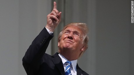 President Donald Trump looks up toward the Solar Eclipse on the Truman Balcony at the White House on August 21, 2017.