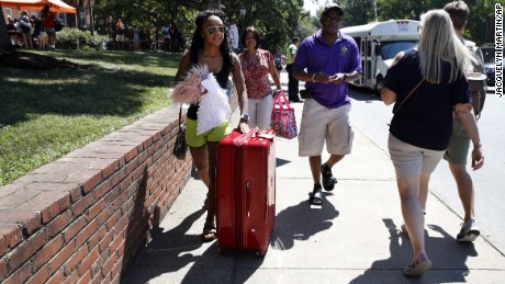 Malia Valentine, 18, of Yorktown, Virginia, and her parents move her into her new dorm at the University of Virginia on Friday.