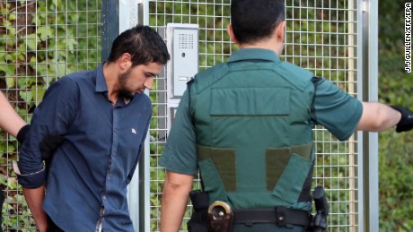 Salah el Karib, one of four suspects arrested in the  attacks, is escorted into court Tuesday in Madrid.