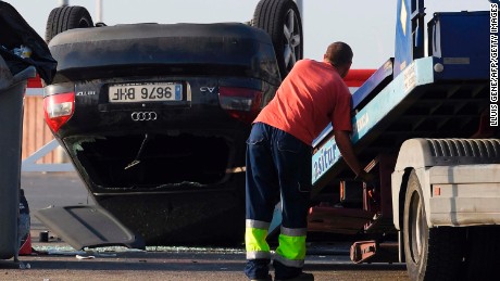 An employee starts to tow away a car involved in a terrorist attack in Cambrils, south of Barcelona.
