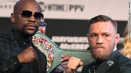 Boxer Floyd Mayweather Jr. (L) and MMA figher Connor Mcgregor pose during a media press conference August 23, 2017 at the MGM Grand in Las Vegas, Nevada. 
Mayweather, the 40-year-old undefeated former welterweight boxing champion, has been lured out of retirement to face McGregor, a star of mixed martial arts&#39; Ultimate Fighting Championship. The two men meet in a 12-round contest under boxing rules on August 26th that is tipped to become the richest fight in history.
 / AFP PHOTO / John Gurzinski        (Photo credit should read JOHN GURZINSKI/AFP/Getty Images)
