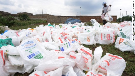 A woman sort out plastic bags after washing them for re-use at the shores of a river in Nairobi, Kenya.