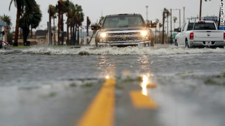 A drives moves through flood waters left behind by Hurricane Harvey, Saturday, August 26, 2017, in Aransas Pass, Texas. Harvey rolled over the Texas Gulf Coast on Saturday, smashing homes and businesses and lashing the shore with wind and rain so intense that drivers were forced off the road because they could not see in front of them. (