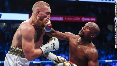 Floyd Mayweather Jr. defeats Conor McGregor by TKO