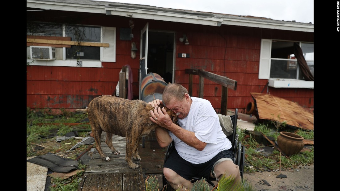 Steve Culver comforts his dog Otis in the hurricane aftermath. Harvey destroyed most of his home in Rockport while he and his wife were there.