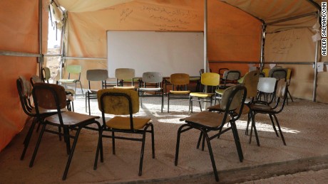 The makeshift tent-school in Jub-El-Thib has chairs but no tables.