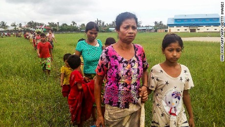 Women and children fleeing violence in their villages arrive at the Yathae Taung township in Rakhine State in Myanmar on August 26, 2017.
Terrified civilians tried to flee remote villages in Myanmar&#39;s northern Rakhine State for Bangladesh on August 26 afternoon, as clashes which have killed scores continued between suspected Rohingya militants and Myanmar security forces. / AFP PHOTO / Wai Moe        (Photo credit should read WAI MOE/AFP/Getty Images)