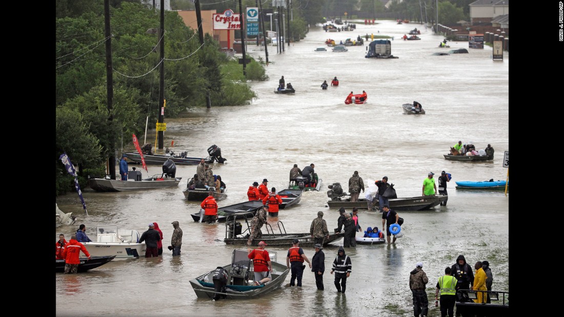 Rescue boats fill Tidwell Road in Houston as they help flood victims evacuate the area.