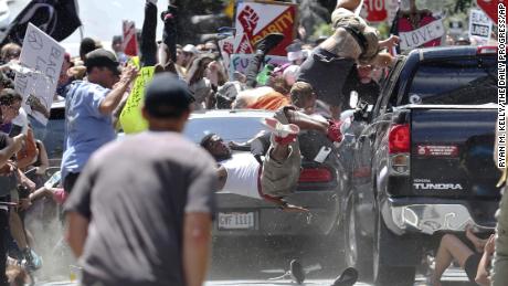 People fly into the air as a vehicle drives into a group of protesters demonstrating against a white nationalist rally in Charlottesville, Va., Saturday, Aug. 12, 2017. The nationalists were holding the rally to protest plans by the city of Charlottesville to remove a statue of Confederate Gen. Robert E. Lee. There were several hundred protesters marching in a long line when the car drove into a group of them. (Ryan M. Kelly/The Daily Progress via AP)