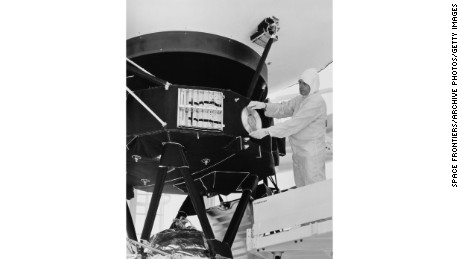 A technician attaches a gold record to a Voyager space probe, USA, circa 1977. 