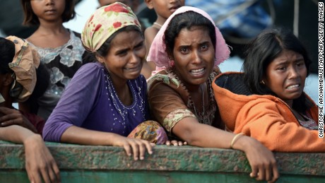 Rohingya migrant women cry as they sit on a boat drifting in Thai waters off the southern island of Koh Lipe in the Andaman sea on May 14, 2015.  The boat crammed with scores of Rohingya migrants -- including many young children -- was found drifting in Thai waters on May 14, according to an AFP reporter at the scene, with passengers saying several people had died over the last few days.     AFP PHOTO / Christophe ARCHAMBAULT        (Photo credit should read CHRISTOPHE ARCHAMBAULT/AFP/Getty Images)