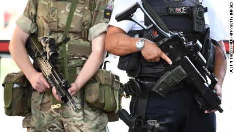 A British Army soldier patrols with an armed police officer near the Houses of Parliament in central London.