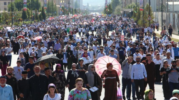 Local residents walk to attend a mass protest in Chechnya
