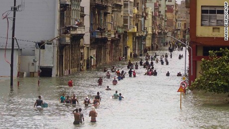 People move through flooded streets in Havana after the passage of Hurricane Irma on Sunday.