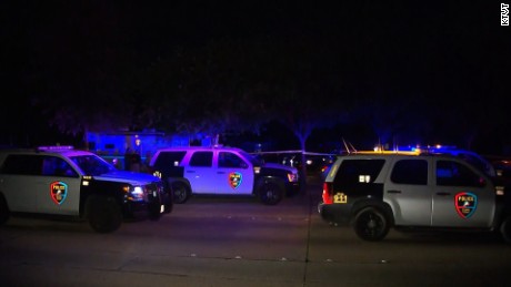 Police vehicles are see outside a home in Plano, Texas, after eight people were shot dead at a gathering where people were to watch a Dallas Cowboys game on the night of Sunday, September 10, 2017.