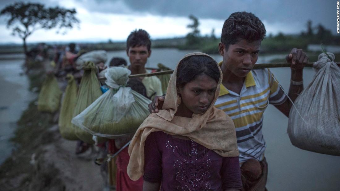 Rohingya refugees walk across paddy fields on September 9, after crossing the border in Gundum, Bangladesh.