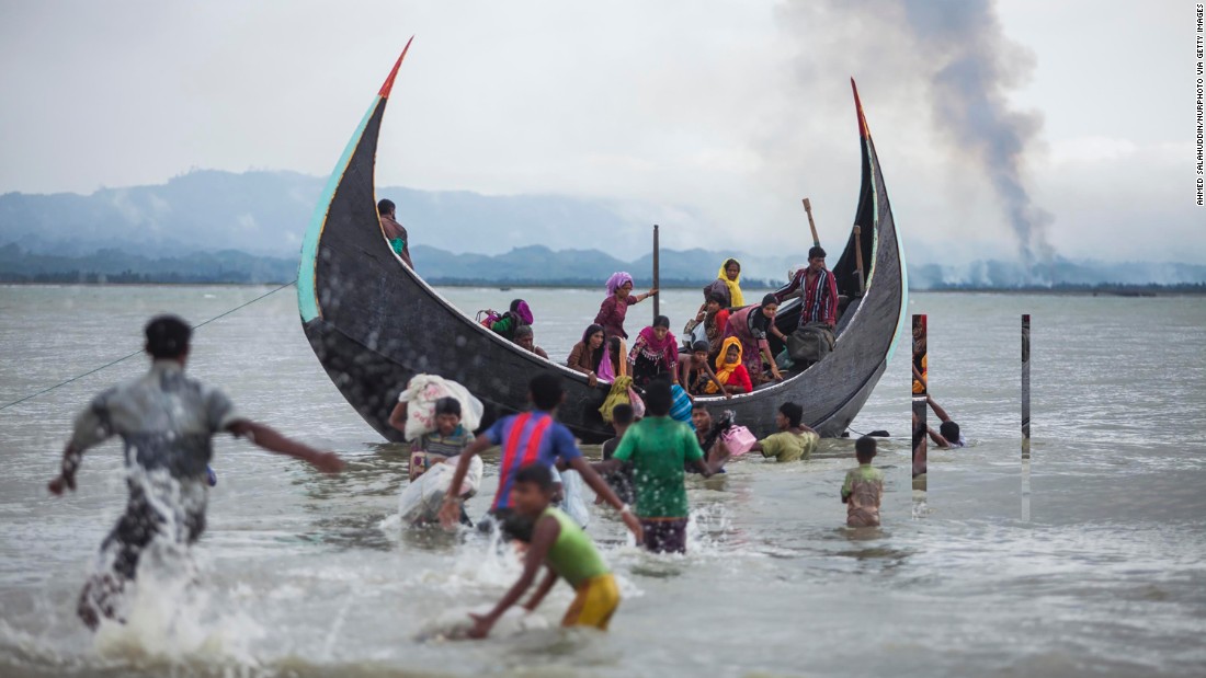 A boat full of Rohingya refugees arrives on September 9, on the Bangladeshi side of the Naf River.