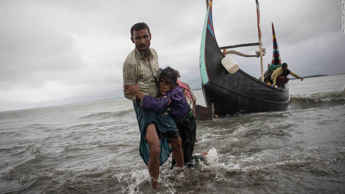 The woman is carried to shore after her boat crashed in Dakhinpara.