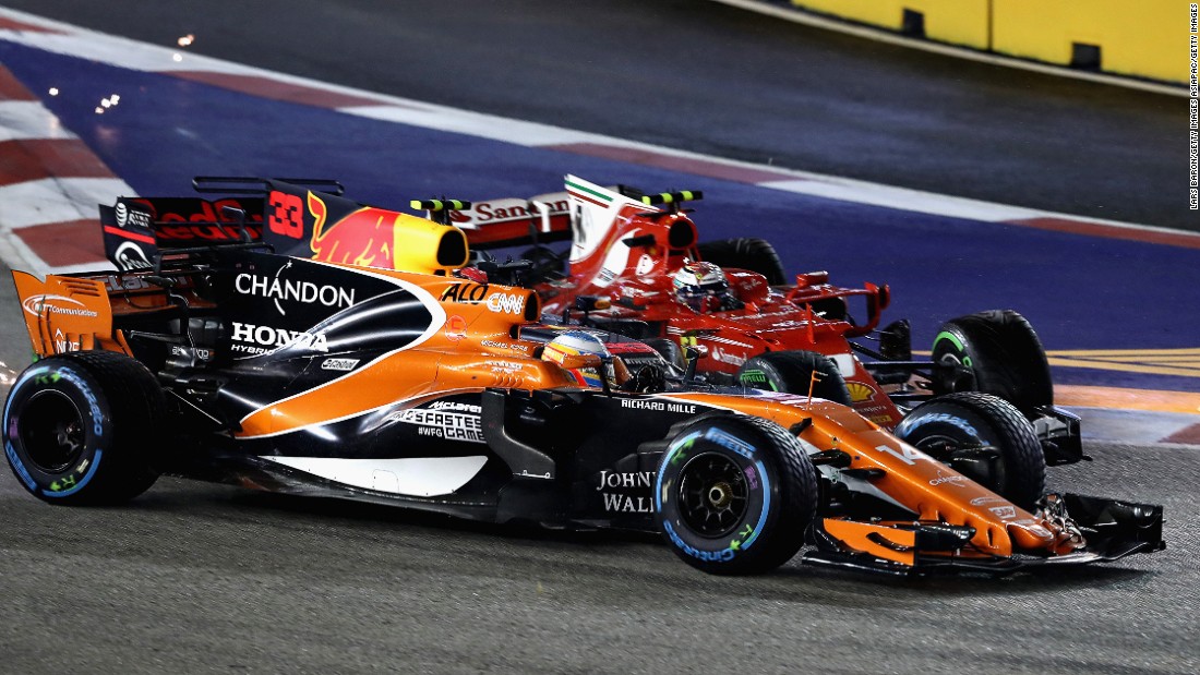 Count the cars... McLaren&#39;s Fernando Alonso, Max Verstappen and Kimi Raikkonen collide at the first corner on lap one of the Singapore Grand Prix.  