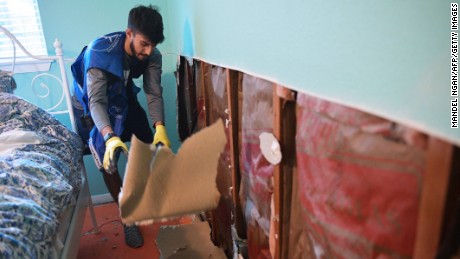 An Ahmadiyya Muslim Youth Association member removes flood-damaged drywall from a home in Houston&#39;s Westbury neighborhood.