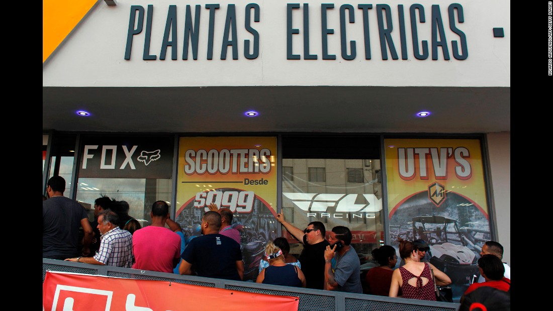 Customers wait in line for power generators at a store in San Juan on September 18.