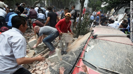 People remove debris of a building which collapsed after an earthquake rattled Mexico City on September 19.