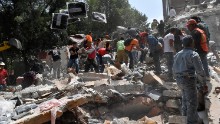 People remove debris of a collapsed building looking for possible victims after an earthquake rattled Mexico City on September 19.