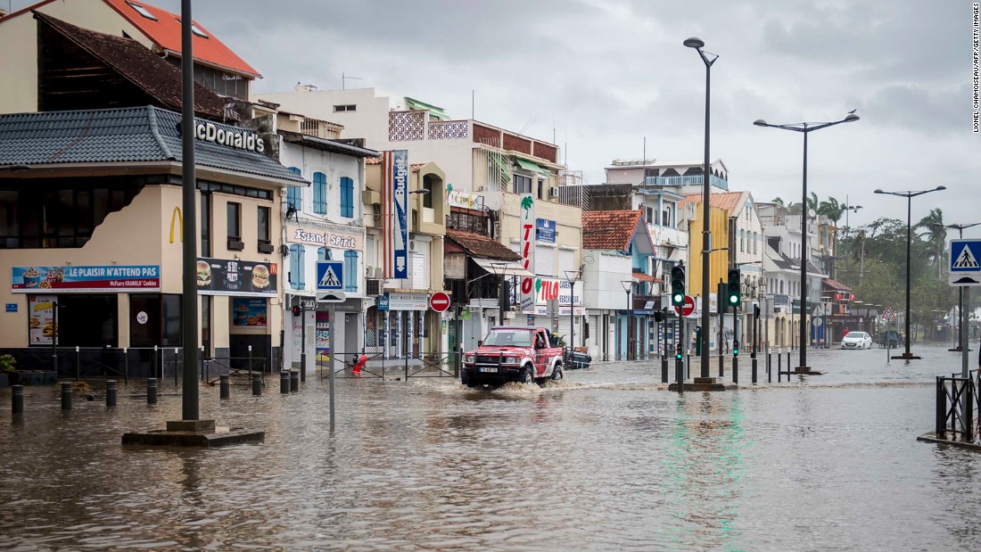 A motorist drives on the flooded waterfront in Fort-de-France, Martinique, on September 19.