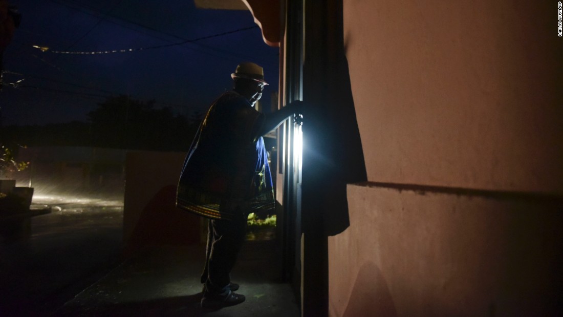 A woman closes her property in Naguabo, Puerto Rico, hours before Maria&#39;s arrival.