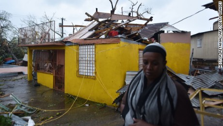 Residents of San Juan, Puerto Rico, deal with damages to their homes on September 20, 2017, as Hurricane Maria batters the island. 
Maria slammed into Puerto Rico on Wednesday, cutting power on most of the US territory as terrified residents hunkered down in the face of the island&#39;s worst storm in living memory. After leaving a deadly trail of destruction on a string of smaller Caribbean islands, Maria made landfall on Puerto Rico&#39;s southeast coast around daybreak, packing winds of around 150mph (240kph).
 / AFP PHOTO / HECTOR RETAMAL        (Photo credit should read HECTOR RETAMAL/AFP/Getty Images)