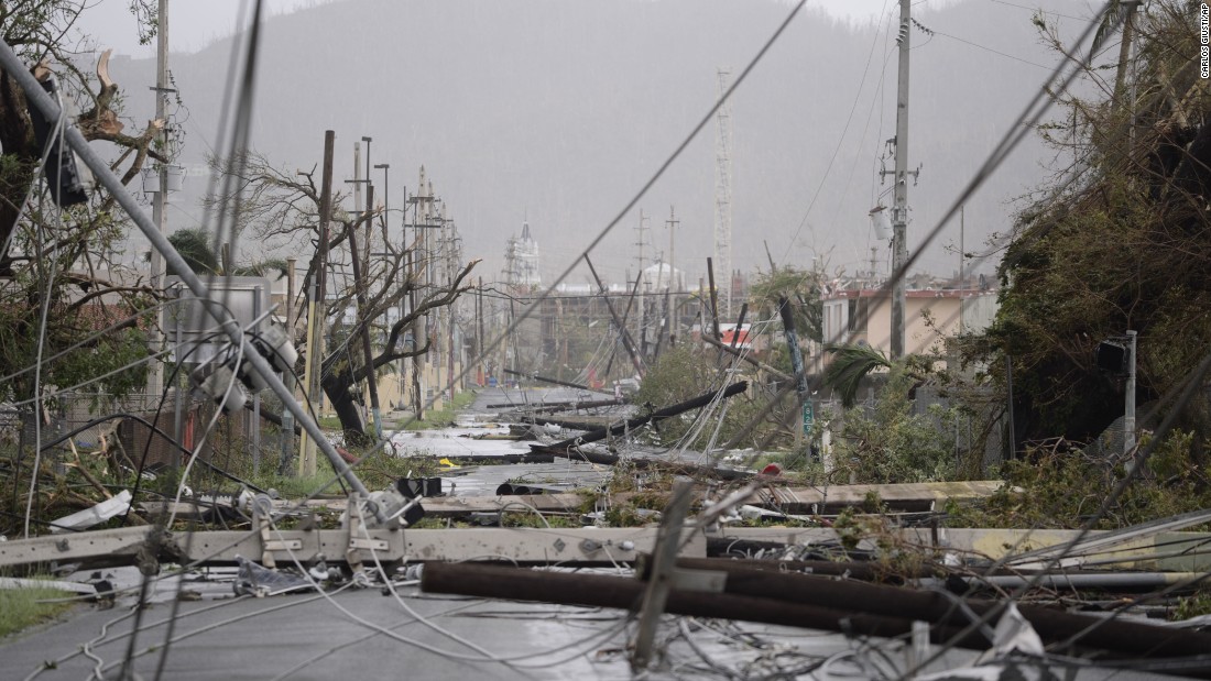 Power lines are scattered across a road in Humacao, Puerto Rico, on September 20.