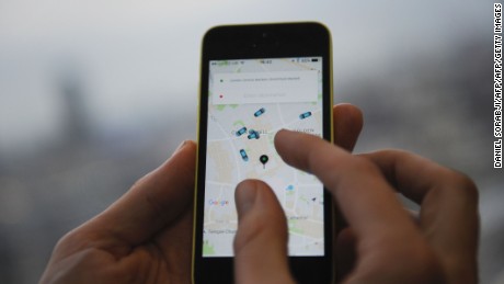 A man poses holding a smartphone showing the App for ride-sharing cab service Uber in London on October 28, 2016. 
Ride-sharing cab service Uber on October 28 lost a British tribunal case brought by drivers demanding basic workers' rights, in a decision that could affect thousands of workers. / AFP / DANIEL SORABJI        (Photo credit should read DANIEL SORABJI/AFP/Getty Images)